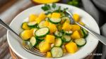 Mixing Cucumber Salad with Tropical Mango